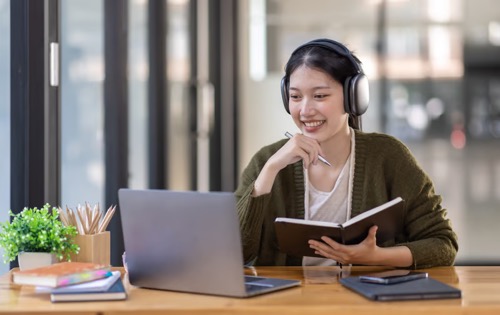 Learner reading with headphones